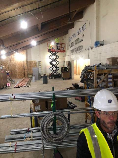 Construction workers working on another area of the Jamie Hosford Football Center.